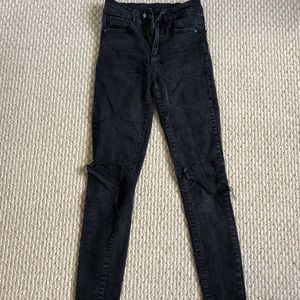 Black jeans with rip at the knee